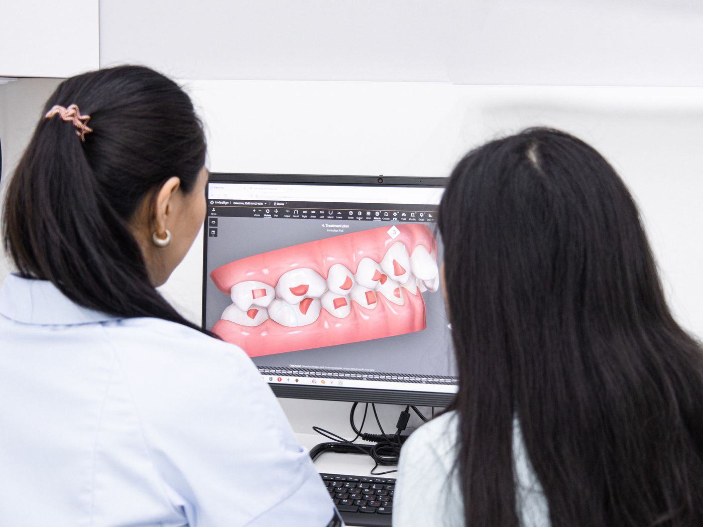 Specialist orthodontists reviewing a digital dental scan